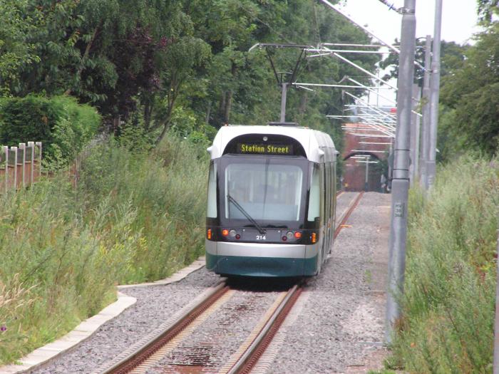 Light rail vehicle on single track with greenery on both sides