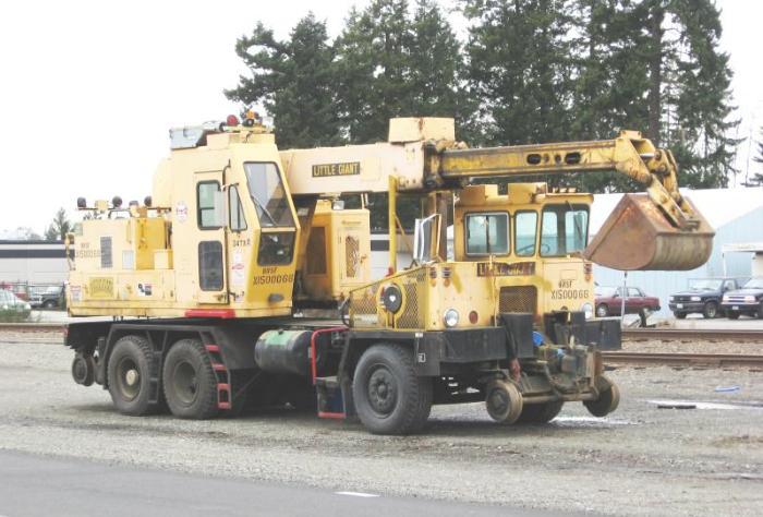 A yellow maintenance vehicle in front of the tracks